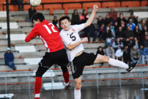 Jamison Wright (right) heads the soccer ball over a White Salmon defender Friday, at Fishback Stadium. The WHS junior delivered a goal and an assist to help the Panthers beat the Bruins 2-0. 