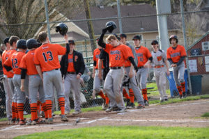 Michael Hickey (27) meets his teammates at home plate after hitting a baseball out of Louis Bloch Park Friday. Washougal defeated Hockinson 7-4 to start league off with two wins. 