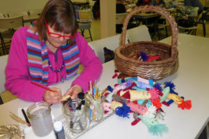 Pam Tucker makes some of the "pocket buddies" that will accompany a shipment of handmade dresses for little girls throughout the world. The dressmakers from Washougal United Methodist Church also pin ribbons and hair bands into the dress pockets.