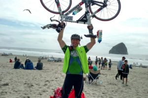 Aaron Reiter holds his bike up after reaching the beach. In 2016, the Camas resident rode 104 miles from Portland to Pacific City for Roxanne Renton, a Camas-Washougal Rotary Club member who suffers from lung cancer. On May 20, Reiter and his friend, Greg Johnson, will particpate in the 2017 Reach the Beach event. (Contributed photo)