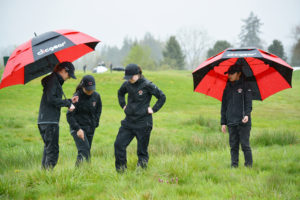 Camas golfers Hailey Oster, Abigail Jiang, Emma Cox and Lauryn Tsukimura discuss their next shot from the deep rough during the Titan Cup Monday, on the Tri-Mountain course in Ridgefield. The Papermakers won all three championship matches. 