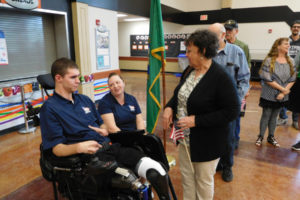 Area residents greet Army Specialist Alex Hussey and his wife, Kim, after a community kickoff event hosted by Homes for our Troops on May 20, at Washougal High School. 