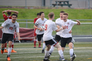 Josh Tkachenko (21) celebrates with his teammates after scoring a golden goal for Camas in the final minute of double overtime Tuesday, at Doc Harris Stadium. The Papermakers beat Sunnyside, of Yakima County, 4-3 in the first round of the state tournament.