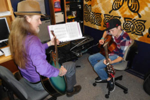 Washougal School of Music owner Jeffree White takes Vance Gooch, 11, of Camas, through his acoustic guitar lesson. (Photos by Dawn Feldhaus/Post-Record)