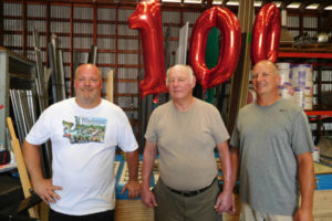 The owners of Washougal Lumber Co., Inc. Brett Scott (left) and his brother, Kevin Scott (right) were joined by their father, John Scott (middle) and mother, Judy Scott (not pictured) at the lumber and hardware store's centennial celebration luncheon, Aug. 4. John and Judy previously owned Washougal Lumber.