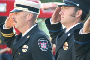 Firefighter-paramedic Mark Widlund (right), pictured here with Camas-Washougal Battalion Chief Mark Ervin (left) at a Sept. 11, 2014 memorial service, recently deployed to Texas to help with disaster relief efforts. (Post-Record file photo)