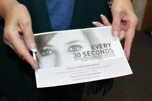 Lesa Sims, a retired youth pastor from the Camas Church of the Nazarene, holds a brochure advertising her church's upcoming informational seminar on human trafficking. The free seminar is designed to educate the public about global, regional and local human trafficking, and teach people how to help prevent sexual and labor exploitation in their own communities. 