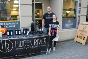 Brandon Pasa (left) and his 10-year-old daughter, Savannah (right), promote Hidden River Roasters, the company Pasa co-founded with Aaron Baldwin (not pictured), outside Pasa’s Columbia Chiropractic & Massage business during the Oct. 6 Camas First Friday event. The coffee roastery will soon have its own downtown Camas location when it moves into the former B&B Fish Market at 536 N.E. Fifth Ave. 