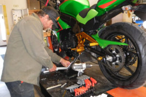 Sunny Adams, co-owner of Motoco Washougal, modifies a kickstand on a customer?s sport bike. The new business also services all-terrain vehicles, motorcycles and street and dirt bikes.