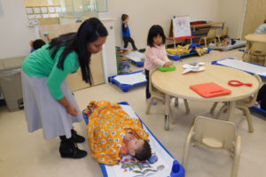 Deepika Ilavarasan, of Camas, talks with a student before he takes a nap at Kiddie Academy, in East Vancouver. Ilavarasan is the academy's director and co-owner with her husband, Vijay Ilavarasan. 