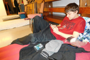 Brandon Merritt, 28, communicates with a friend via Facebook Messenger, while relaxing in a severe weather shelter Thursday, Feb. 22, at St. Matthew Lutheran Church, in Washougal. The site, at 716 Washougal River Road, will be open from 6 p.m. to 7 a.m., when the forecast is 30 degrees or lower, or if ice or snow are expected, and there are enough volunteers to be there, particularly from 11 p.m. to 5 a.m. 