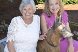 Washougal City Councilwoman Joyce Lindsay (left), a Washougal Arts and Culture Alliance (WACA) board member, celebrates the Aug. 5,  2017 dedication of "Forever Faithful," a life-size bronze sculpture of a Belgian Malinois created by Susan Bahary (right). The artwork is located in front of the Washougal Police station. Lindsay is resigning her seat on the Washougal City Council, but plans to continue serving on the WACA board  after she moves to Bellingham later this year. (Contributed photo by Rene Carroll)