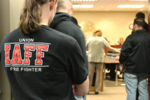 Members of the local International Association of Fire Fighters union stand in the hallway of Camas City Hall on Monday, March 19, at a Camas City Council meeting.