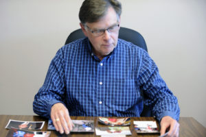 Steve Hofmaster, of Camas, looks through family photos of his mother, Marie Hofmaster, who died at the age of 94, on June 6, 2014. 