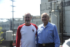 Kraig Nichols (left) and his father, Jerry Nichols (right), stand in the employee parking lot overlooking the Georgia-Pacific paper mill in downtown Camas on Tuesday, April 24. Kraig and Jerry were part of the original start-up crew on the mill's No. 20 paper machine in 1984. Jerry has since retired, but Kraig is now part of the No. 20 shutdown crew. 