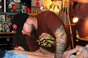 Ryan "Boomer" Boomhower, owner of 3rd Heart Tattoo in downtown Washougal, prepares his client, Tiffany Renteria, of Vancouver, for her new tattoo, on Thursday, April 26. Boomhower will show his original tattoo designs as well as oil paintings at the inaugural Washougal Studio Artists Tour on Mother's Day weekend, May 12-13 at 3rd Heart Tattoo, 1830 Main St., Washougal.