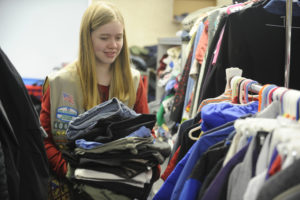 Natalie Galloway, a member of Girl Scout Cadette Troop 40605, of Washougal, helps sort pants at the Family Resource Clothing Closet, at Hathaway Elementary School, in Washougal. The closet provides free clothing and shoes, and free use of a washer and dryer, for residents of the Washougal School District from 4 to 6 p.m., on the second and fourth Thursday of each month. 