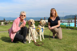 Canine Companions for Independence puppy raisers Millie Bowens (left) and Susan Manuel (right), pose with the puppies they've raised since the pups were 8 weeks old: 13-month-old Tanveer (second from left) and 20-month-old Maggie (second from right) at Marina Park, near the Port of Camas-Washougal marina, on May 4. 