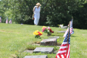 Small flags are placed on veterans’ graves in the Washougal Memorial Cemetery, in 2016. (Post-Record files)