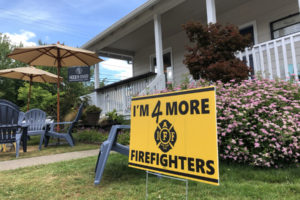 A sign showing support for increasing staffing levels at the Camas-Washougal Fire Department sits outside Hidden River Roasters in downtown Camas. 