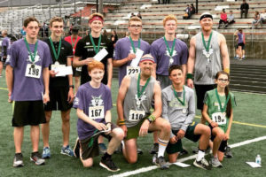 Gabriel Dinnel (second to left, back row) smiles at last month's STRIDE for Education event at Washougal High School. Dinnel fell in love with running after winning his first race as a kindergartner at STRIDE. He's competed every year since, for the past 11 years, and has won every race. (Photo courtesy of Rene Carroll, for Washougal School District)