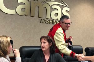 Camas Mayor Scott Higgins (right), wearing his Camas High letterman's jacket and clutching his trademark Camas High Papermakers water bottle, shakes hands with various department heads after a special Camas City Council meeting Monday night, during which the two-term mayor announced his resignation, effective Sept. 30. His term expires on Dec. 31, 2019. Higgins cited a desire to spend more time with family as his reason for leaving, but said he wanted to stay through September to deliver one final 