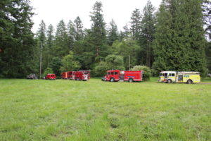 First responders gather on an access road near Lacamas Park in June 2017 to assist with the recovery of a Camas mother, Alisha McRay, whose body was found in the Lacamas Park 