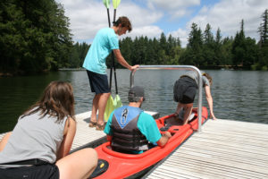 Zach Macia from Sweetwater Rentals provides safety tips to first-time kayakers, Mat and Marty Sampson, on Lacamas Lake. 