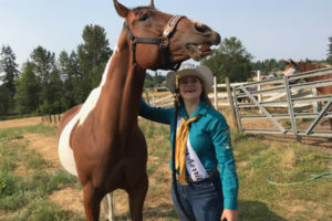 Korrie MacIntyre, 18, and her horse, Dennis, smile for the camera as MacIntyre scratches Dennis' favorite spot on Monday, July 30. MacIntyre, who has been a part of the Clark County Fair since she was 10 years old, is a princess on the 2018 Riverview Community Bank Clark County Equestrian Fair Court. 