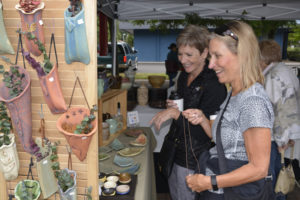 Shoppers flock to the 2017 Washougal Art Festival in downtown Washougal. This year's festival features regional, juried artists and will be held from 9 a.m. to 4 p.m., Saturday, Aug. 11, in Washougal's Reflection Plaza. For more information, visit washougalarts.org. (Contributed photo courtesy of Rene Carroll)