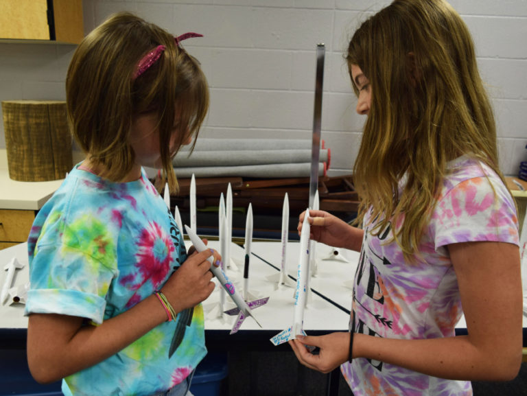 Incoming sixth-grade Skyridge students Arielle Greenstone (left) and Sarah Heigl (right) share about the rockets they created during camp.