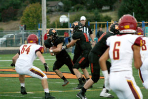 Washougal's Brevan Bea takes the handoff from quarterback Dalton Payne. Bea scored two touchdowns in the first half against Prairie, including a pick six from 75 yards out. 