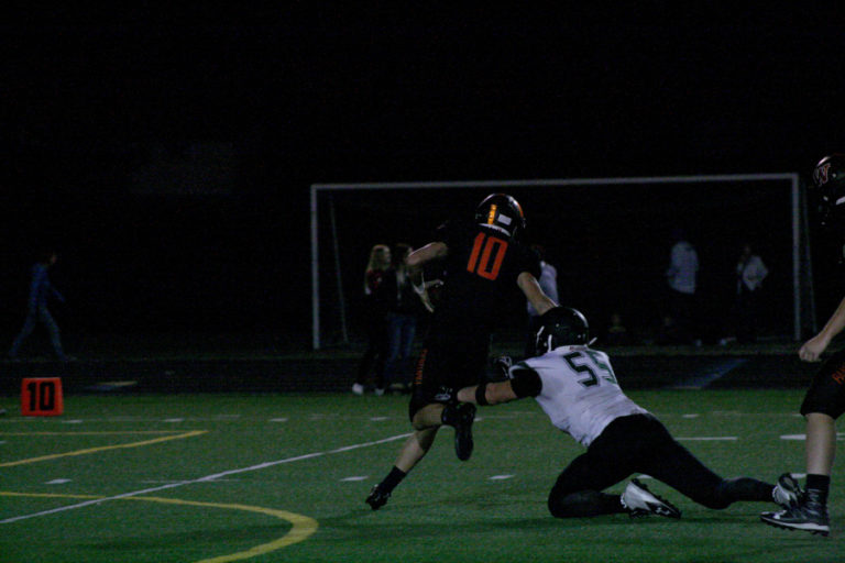 Washougals junior quarterback Dalton Payne scrambles out of a tackle against Woodland on Friday, Sept.