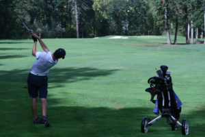 The Papermakers' No. 1 player, Owen Huntington, fires a shot at the pin at Camas Meadows. Huntington has been dealing with a sore back, but says he's improving quickly, thanks to physical therapy. 