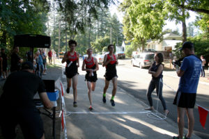 From left to right: Luc Utheza, Spencer Twyman and Daniel Jackson cross the finish line together as the Camas Papermakers boys cross-country team ran to an easy victory over Union High, Sept. 25, at Round Lake in Camas. 