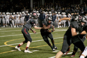 Camas High quarterback Blake Ascuitto (left) hands off to running back Jacques Badalto-Birdsell (second from left) during the homecoming game against Skyview, Oct. 19.  Both players stepped up and successfully filled in for injured starters.