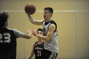 Senior Carson Bonine throws a no-look pass during a recent practice. Bonine has been the leading scorer in the first few games of the season.