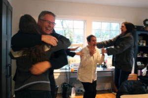 Members of the Downtown Camas Association (DCA), including Camas Parks and Recreation Chair Randy Curtis (second from left), Maria Maria Gonser, owner of Attic Gallery (left), DCA Executive Director Carrie Schulstad (second from right) and Arktana owner Ann Matthews (right) react with shock and joy Tuesday morning after Camas was named one of 10 cities in the running for the web series "Small Business Revolution." (Kelly Moyer/Post-Record)