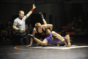 Scott Lees scores points with a move on Miguel Fuentes from Columbia River during the first home meet of the season on Wednesday, Dec. 12. 