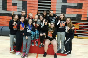 The Washougal girls wrestling team holds their eighth Clark County Wrestling Championship trophy. (Photo courtesy of Heather Carver)