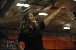 Britney Knotts, Washougal's head girls basketball coach, twirls a piece of the net after the program's first-ever undefeated league season.