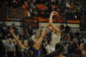 Washougal senior Beyonce Bea shoots over two defenders at a recent home game. Bea finished strong in a Feb.  22 game against No. 2-ranked East Valley, leading all scorers with 22 points, as the Panthers clinched a spot in the state quarterfinals. (Post-Record file photos)