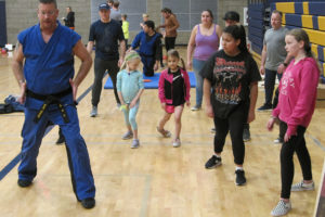 Gary Fowler of Northwest Champions Martial Arts (left) instructs a group of students during Washougal School District's Family Fitness Night, held Feb. 28 at Jemtegaard Middle School and Columbia River Gorge Elementary School. 