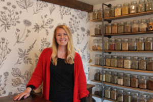 Avery Colby, a naturopathic doctor, stands inside her new Petal and Thorn Naturopathic Wellness Center and Apothecary on March 28. 