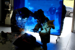 SIGMADESIGN welder Ryan Zahniser (left) shows Jameson Baerwaldt how to weld at the Camas-based product design and engineering firm on April 25.