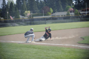 Washougal senior Zach Collins slides into third base against Woodland on April 29. A Panther win would have clinched a playoff berth, but Washougal lost the game 5-2.