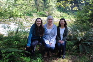 Vancouver artist Sam Marroquin (right) sits outside TreeSong Retreat Center in Washougal with TreeSong's director Michelle Fox (center) and Artist in Residence program manager Monica Vilhauer (left). (Artworks contributed by Sam Marroquin)