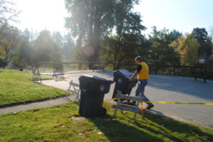 Garry Reed, Camas' sanitation lead, wheels bins to his truck in October 2018. The city will change garbage, recycling pick-up days and times for thousands of customers in June. (Post-Record files)