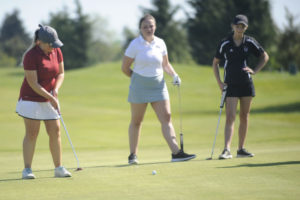 Camas senior Ashley Clark drains a putt on hole No. 18 at the district golf championships in Ridgefield on May 6.  Clark finished second with a two-round score of 163. 