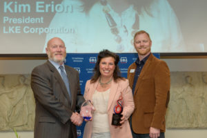 Kim Erion, president of LKE Corporation (center), receives her award from the U.S. Small Business Administration. (Courtesy of the Small Business Administration)